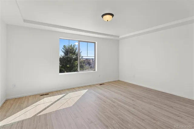 a view of livingroom with an entryway and wooden floor