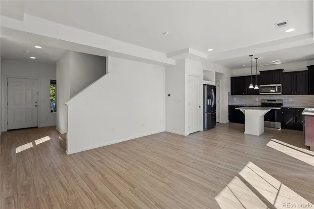 a view of an empty room and wooden floor