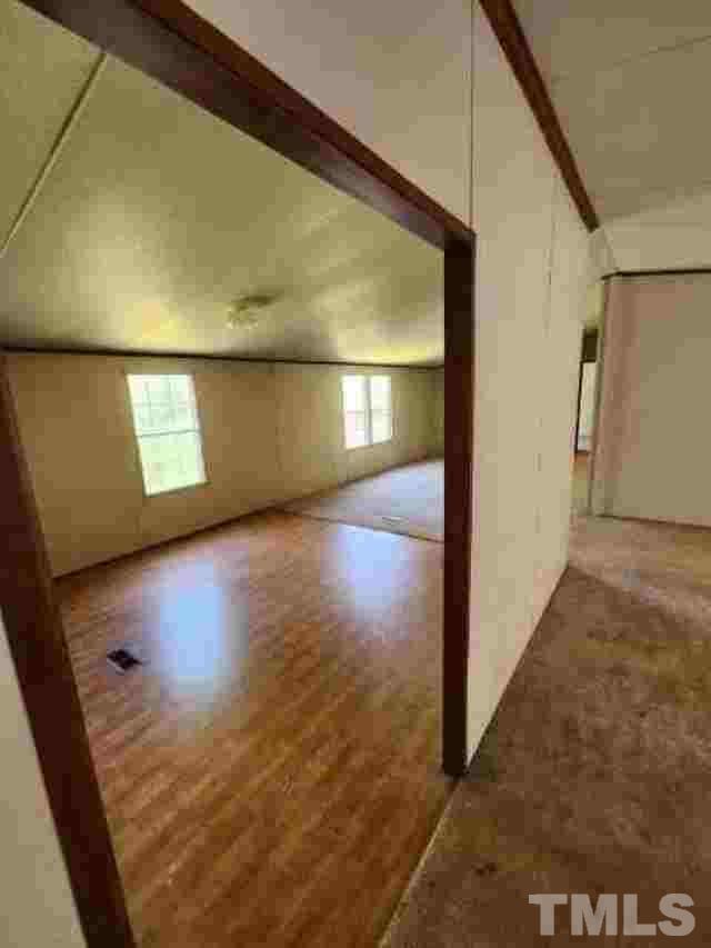 165 Bella Russell Road Manson, NC 27553 - Photo 3 of 7 a view of a big room with wooden floor and windows