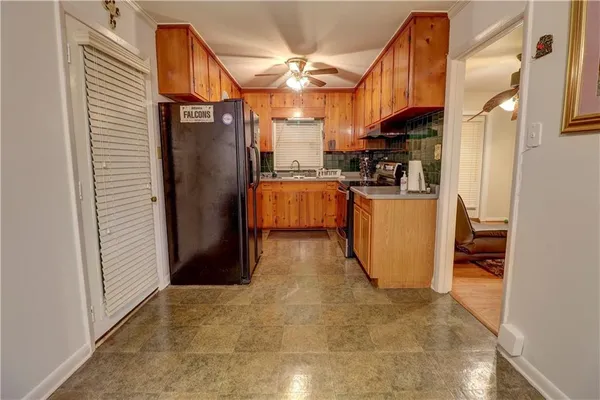 a kitchen with refrigerator and cabinets