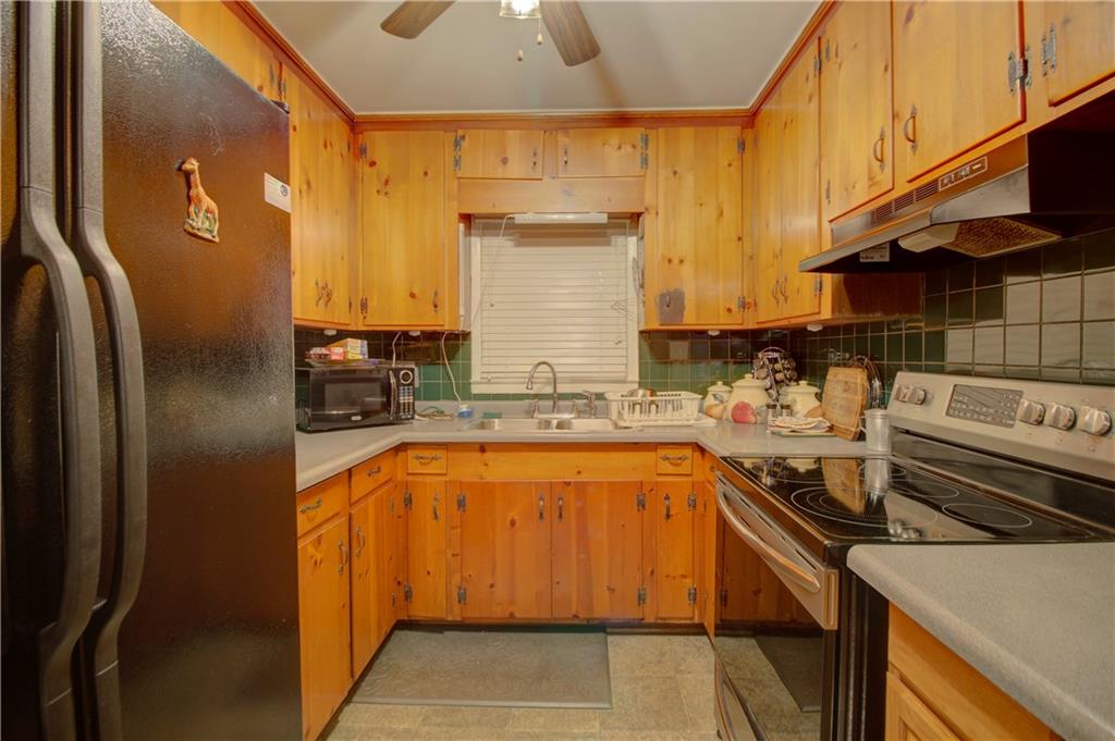 281 Springdale Drive Winder, GA 30680 - Photo 4 of 12 a kitchen with stainless steel appliances granite countertop a sink stove and refrigerator