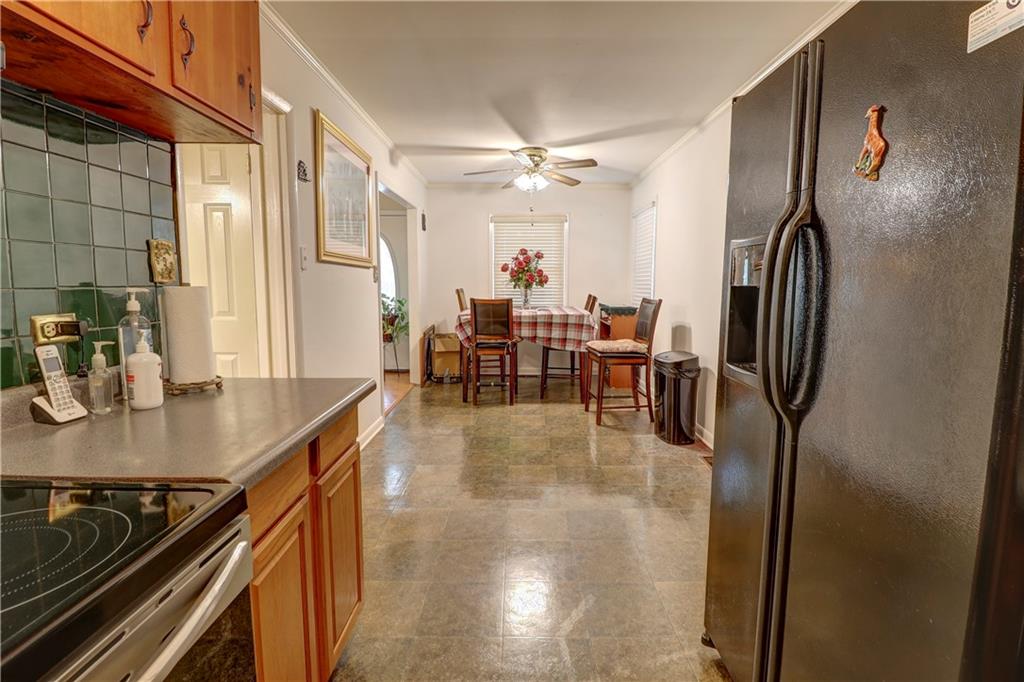 281 Springdale Drive Winder, GA 30680 - Photo 5 of 12 a dining hall with stainless steel appliances granite countertop a dining table chairs and a refrigerator