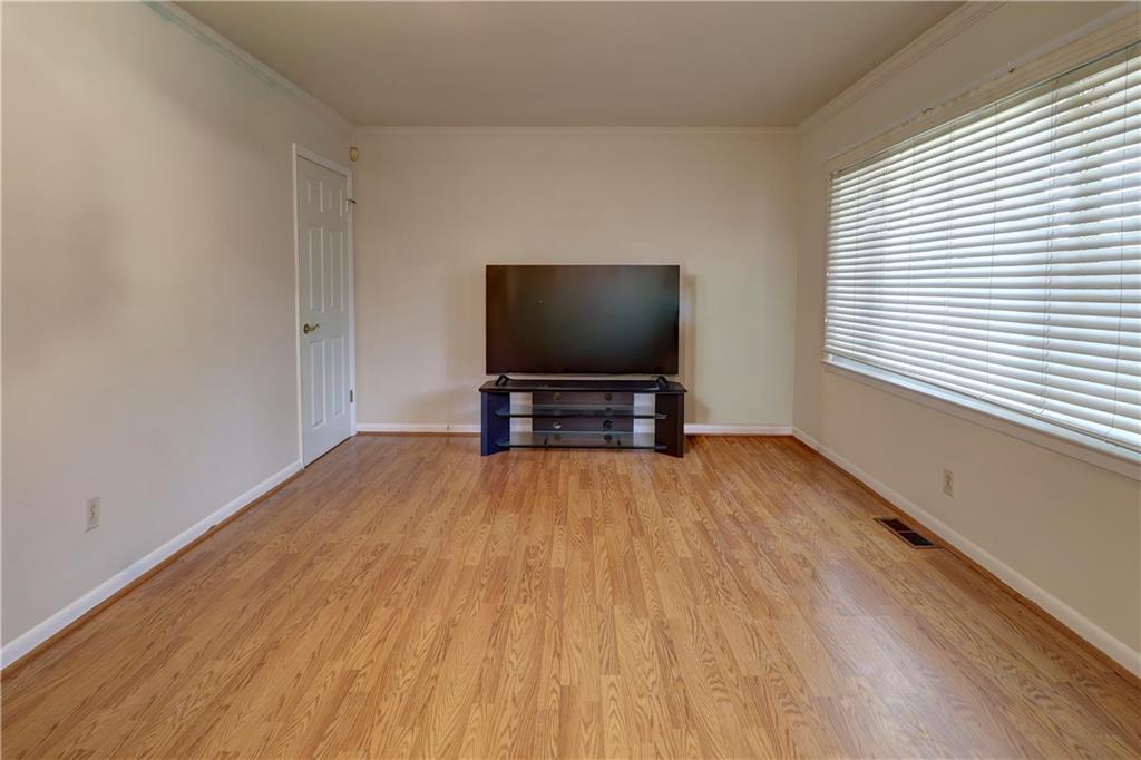 281 Springdale Drive Winder, GA 30680 - Photo 6 of 12 a view of room with wooden floor and flat screen tv