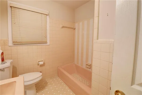 a bathroom with a toilet a sink and bathtub