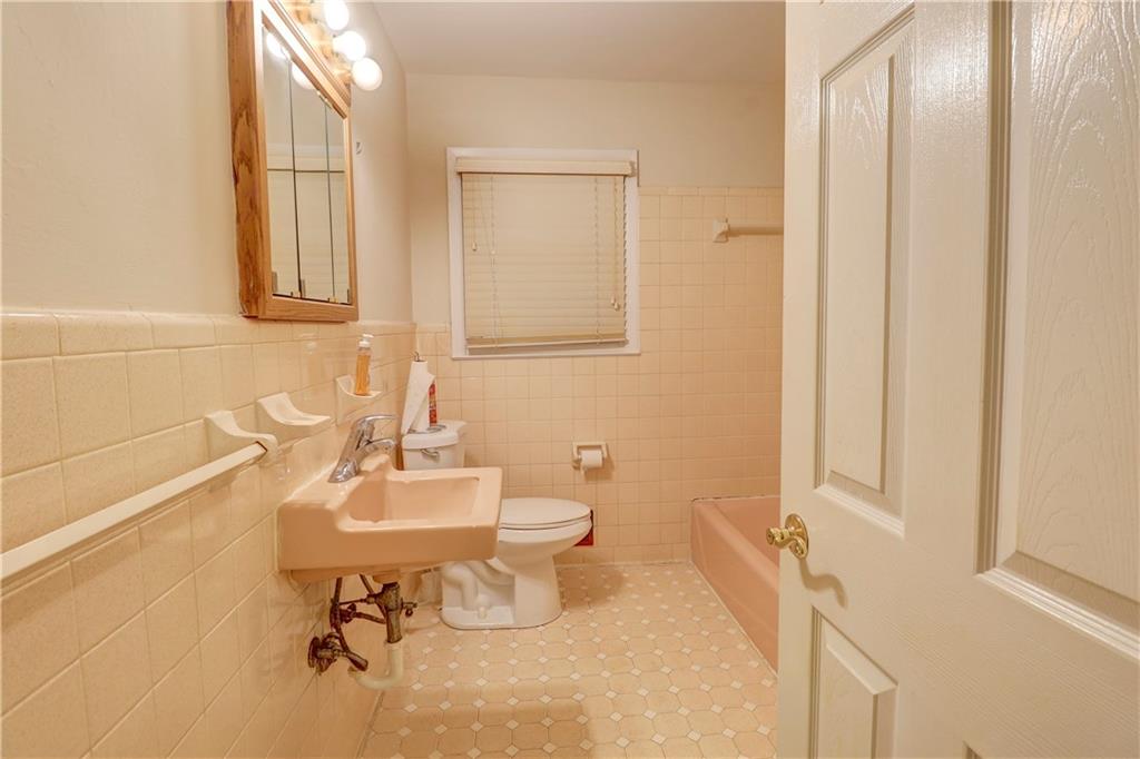 281 Springdale Drive Winder, GA 30680 - Photo 9 of 12 a bathroom with a sink mirror and toilet