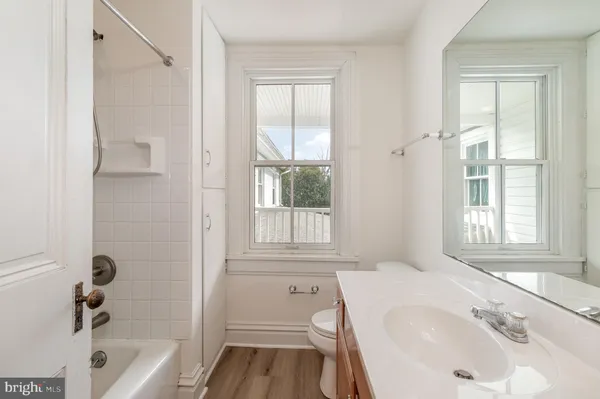 a bathroom with a tub sink and window