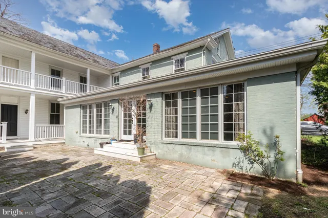 a front view of a house with a yard in front of main door