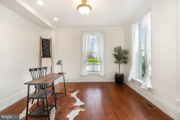 a view of a livingroom with furniture and a window