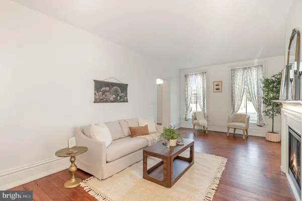a living room with furniture and wooden floor
