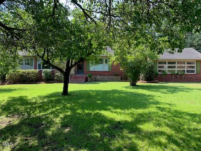 a view of house with backyard