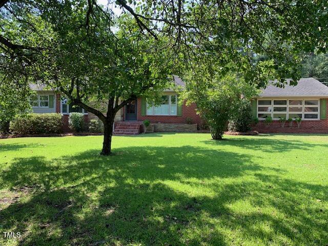 a view of house with backyard