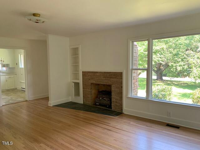 1003 Summerville Mamers Road Lillington, NC 27546 - Photo 17 of 44 a view of an empty room with wooden floor and a window