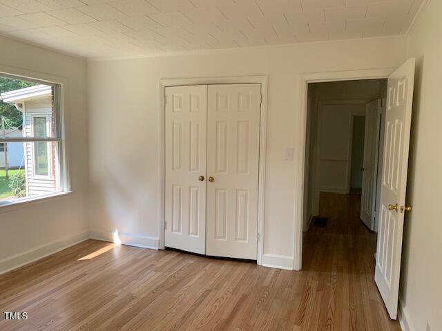 1003 Summerville Mamers Road Lillington, NC 27546 - Photo 20 of 44 an empty room with wooden floor and windows