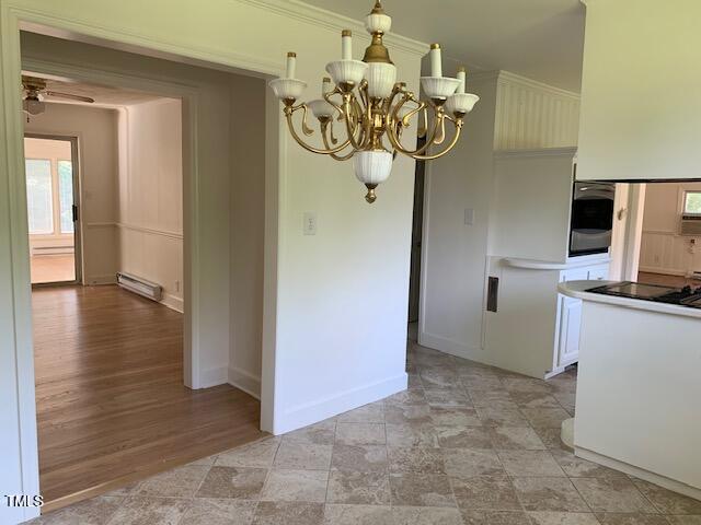 1003 Summerville Mamers Road Lillington, NC 27546 - Photo 4 of 44 a view of a hallway with wooden floor and chandelier