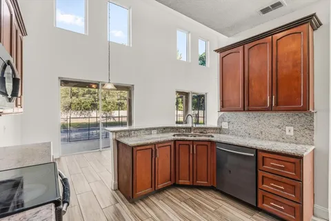 a kitchen with a sink stove and cabinets