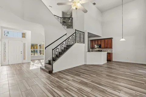 a view of entryway and hall with wooden floor