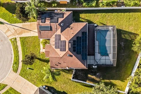 an aerial view of residential house with outdoor space and swimming pool