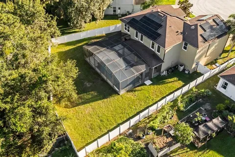 a view of a swimming pool with two chairs next to a yard