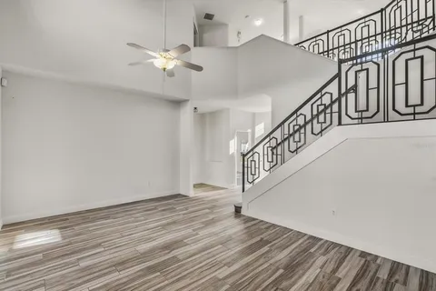 a view of entryway and hall with wooden floor
