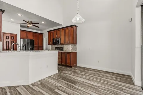 a kitchen with stainless steel appliances granite countertop a stove a sink and a refrigerator