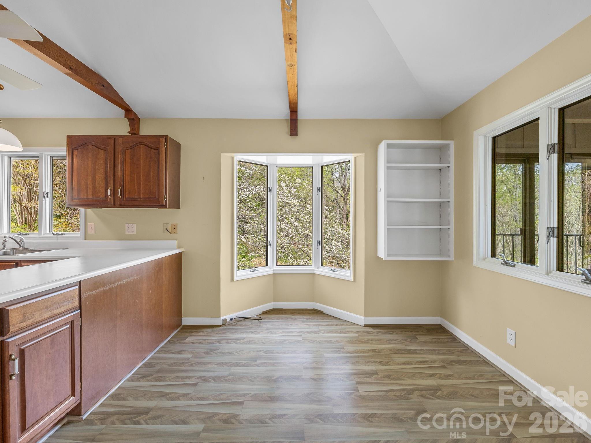 140 Meadowlark Drive Tryon, NC 28782 - Photo 13 of 45 a view of a kitchen with a sink dishwasher and wooden floor