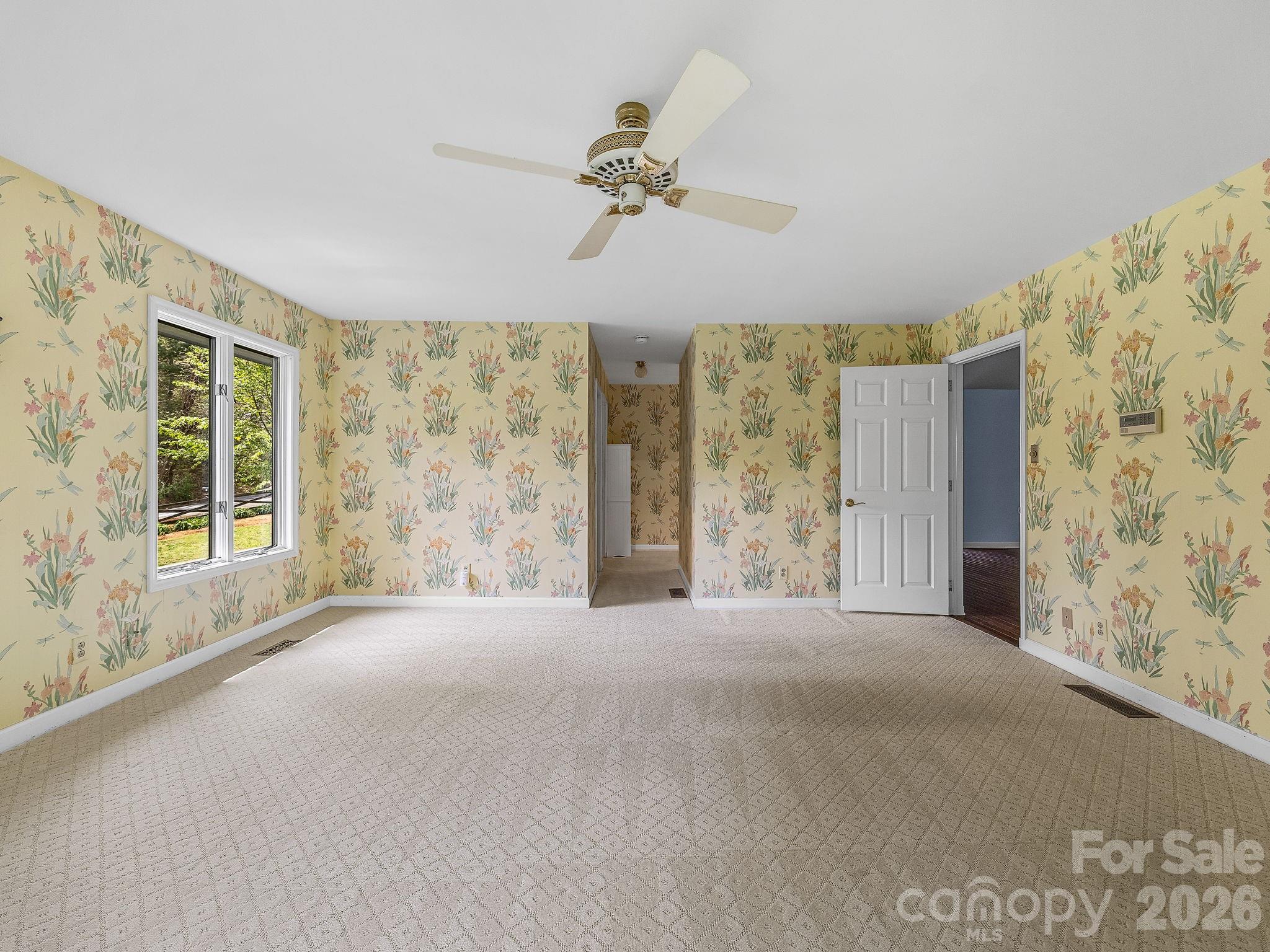 140 Meadowlark Drive Tryon, NC 28782 - Photo 19 of 45 a view of a livingroom with a window and a ceiling fan