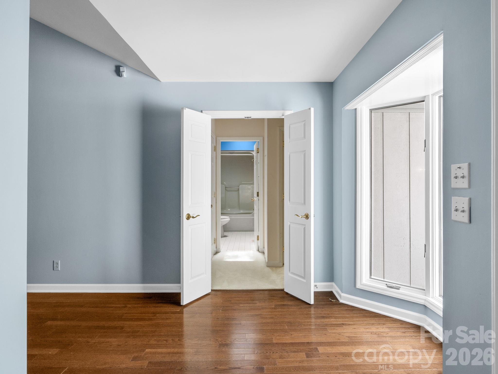 140 Meadowlark Drive Tryon, NC 28782 - Photo 23 of 45 an empty room with wooden floor and door