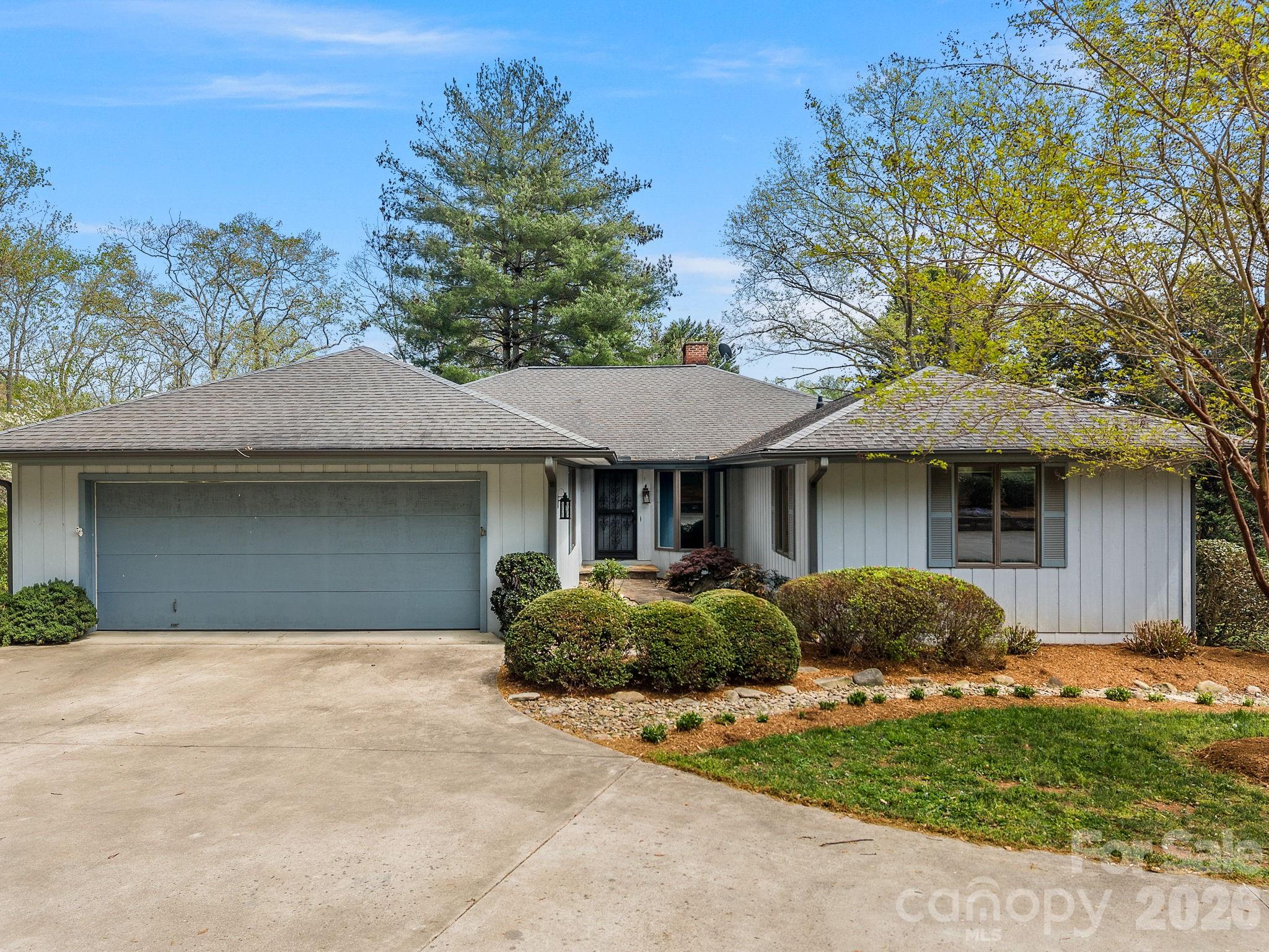 140 Meadowlark Drive Tryon, NC 28782 - Photo 3 of 45 a front view of a house with a garden