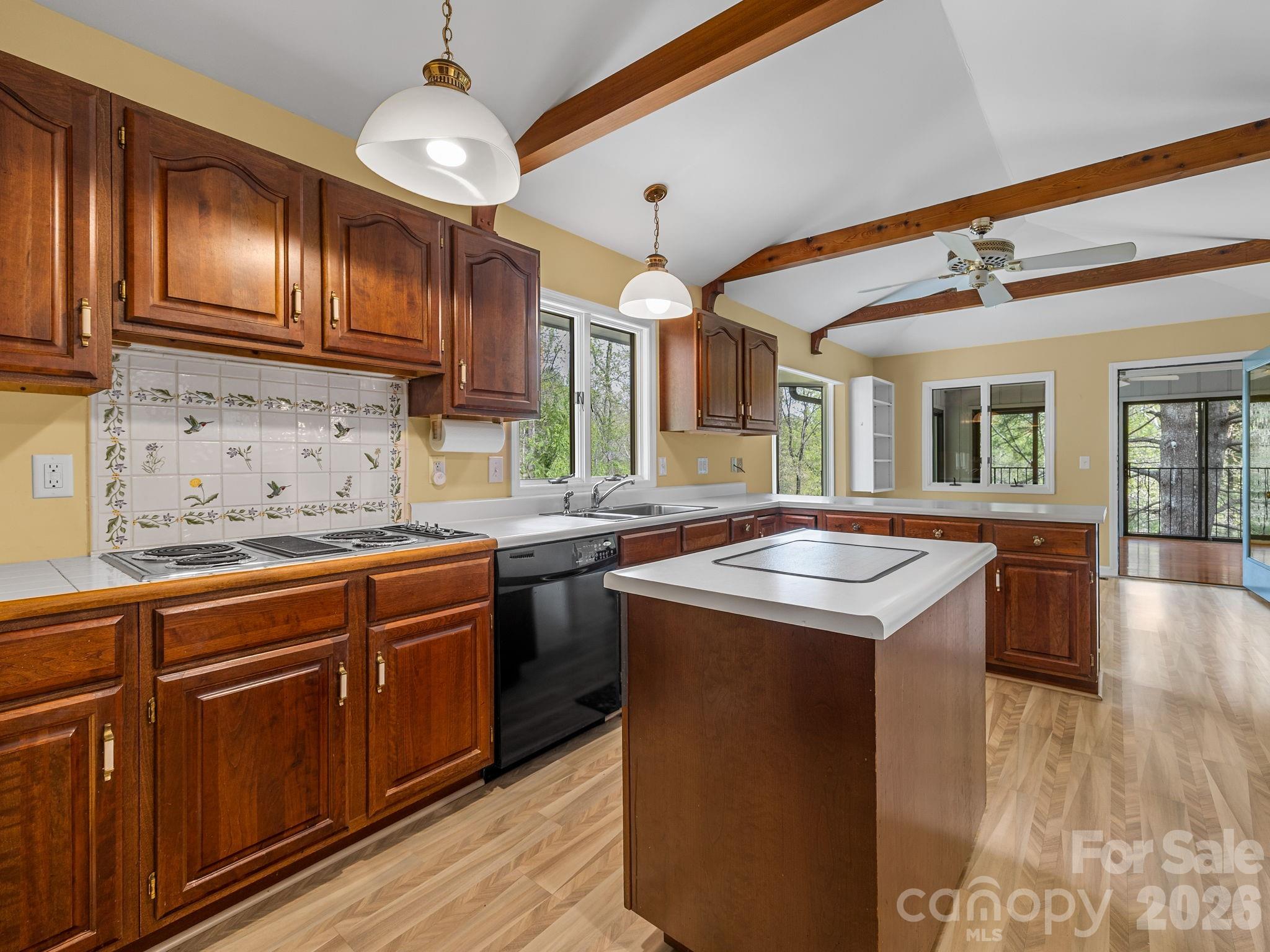 140 Meadowlark Drive Tryon, NC 28782 - Photo 9 of 45 a kitchen with stainless steel appliances granite countertop a sink stove and wooden cabinets