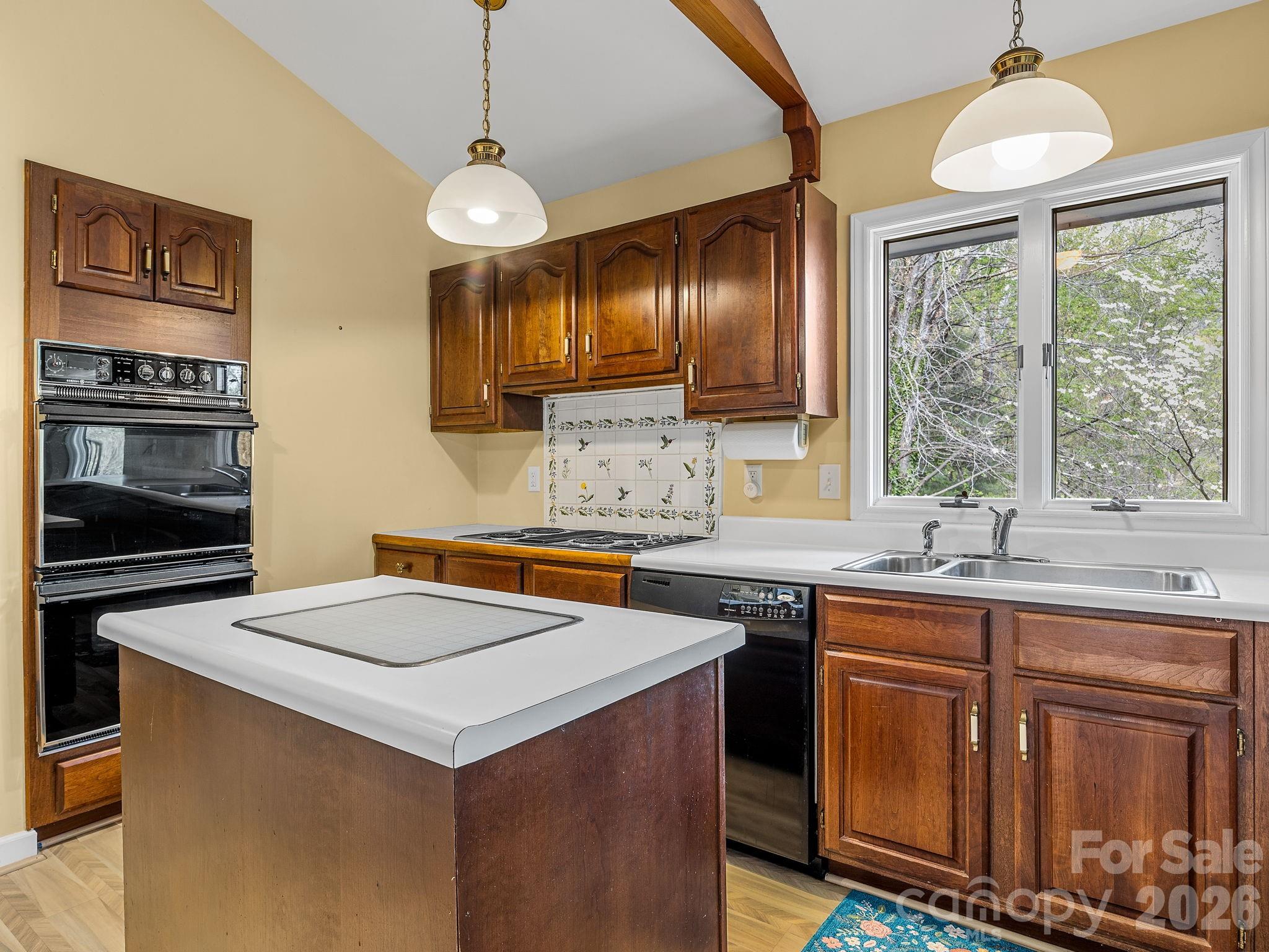 140 Meadowlark Drive Tryon, NC 28782 - Photo 10 of 45 a kitchen with stainless steel appliances a sink stove and microwave