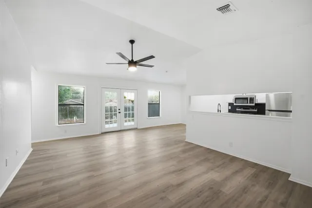 a view of a livingroom with furniture wooden floor and window