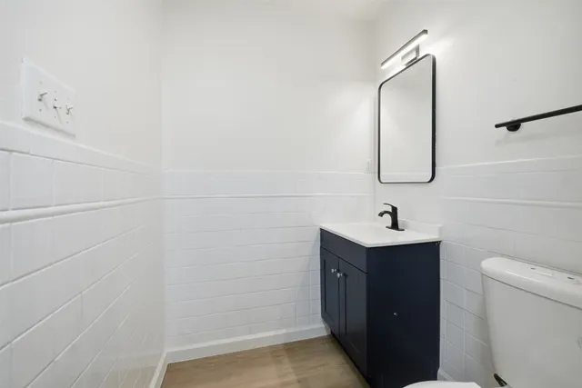 a bathroom with a sink a toilet and mirror