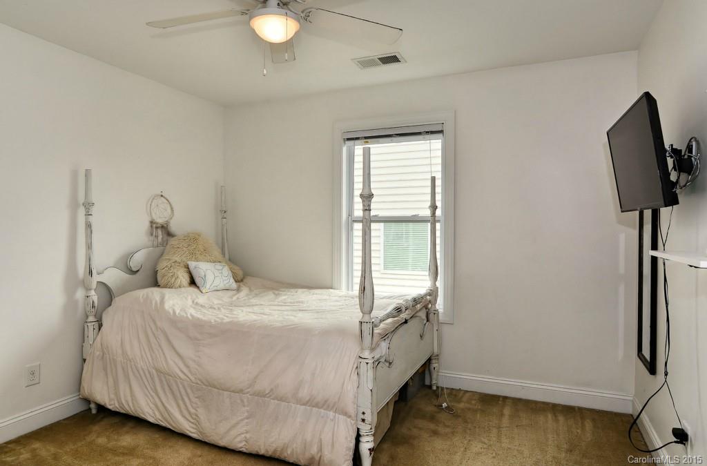 1004 Ridgehaven Road Waxhaw, NC 28173 - Photo 12 of 24 a bedroom with a bed and a flat tv screen on the dresser