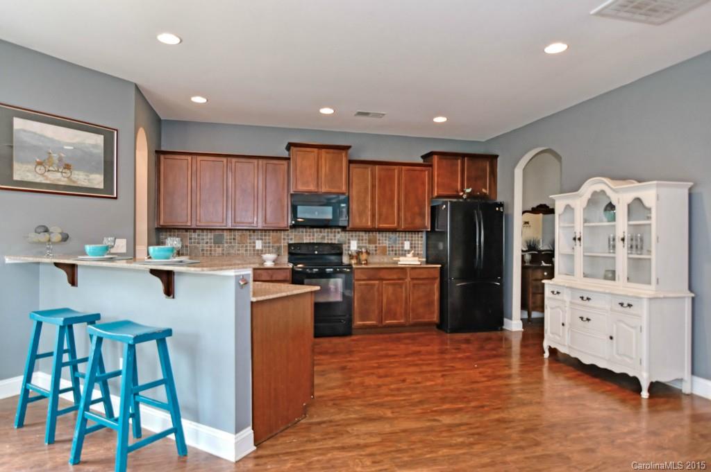 1004 Ridgehaven Road Waxhaw, NC 28173 - Photo 4 of 24 a kitchen with stainless steel appliances granite countertop a refrigerator and a stove top oven