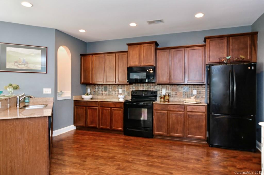 1004 Ridgehaven Road Waxhaw, NC 28173 - Photo 5 of 24 a kitchen with stainless steel appliances granite countertop a refrigerator stove top oven and sink