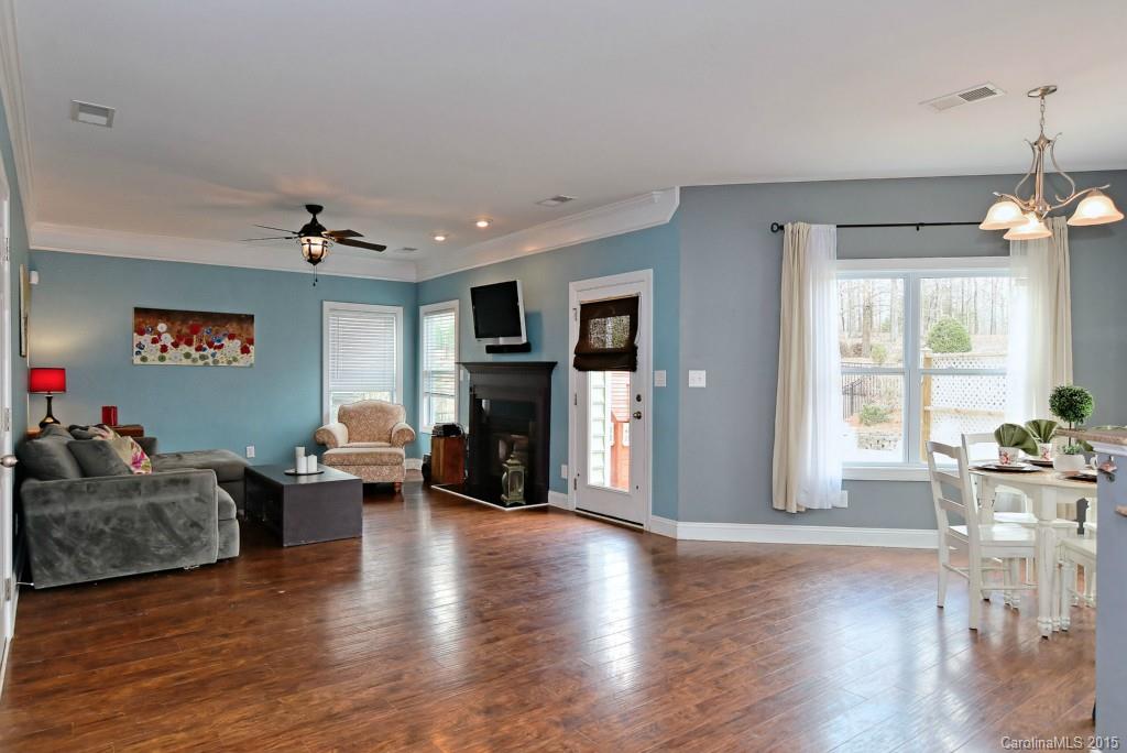 1004 Ridgehaven Road Waxhaw, NC 28173 - Photo 7 of 24 a living room with fireplace furniture and a wooden floor