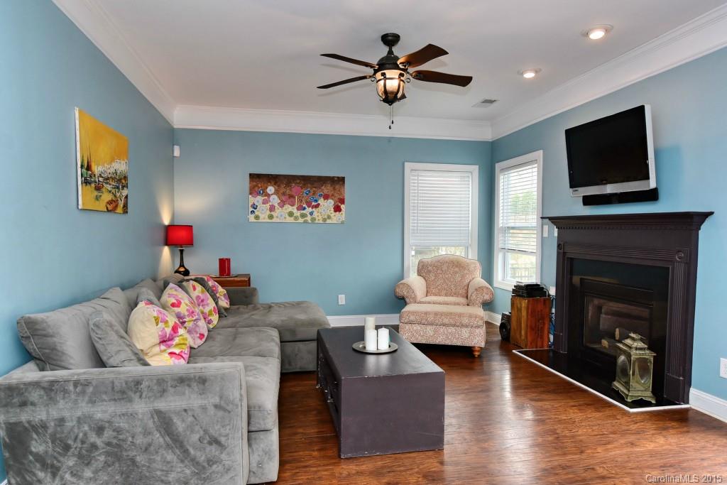 1004 Ridgehaven Road Waxhaw, NC 28173 - Photo 8 of 24 a living room with furniture a flat screen tv and a fireplace