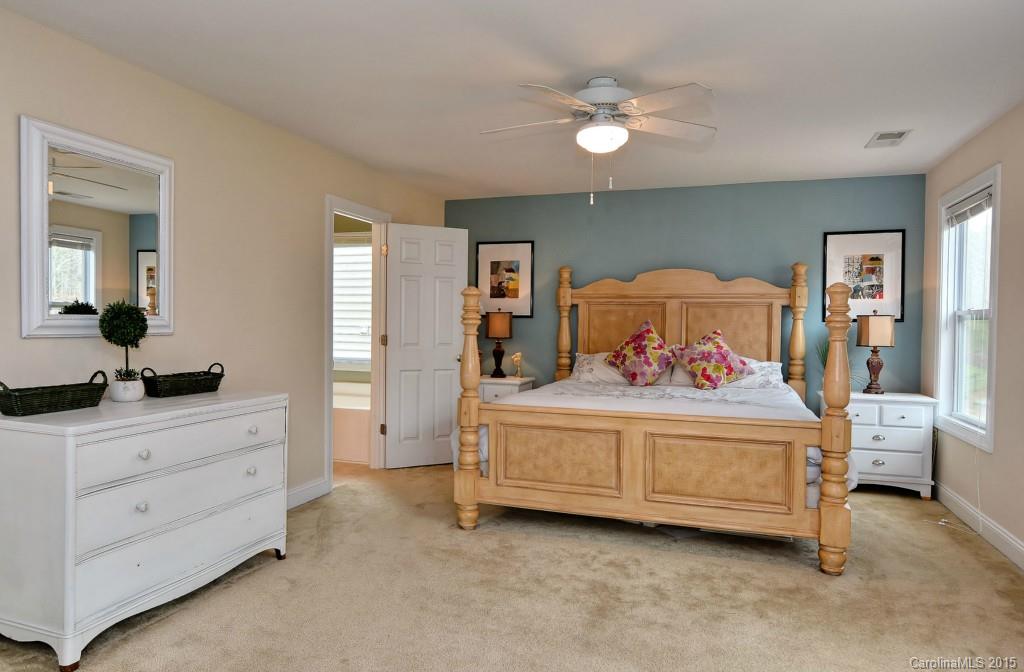 1004 Ridgehaven Road Waxhaw, NC 28173 - Photo 9 of 24 a bedroom with a bed and a chandelier