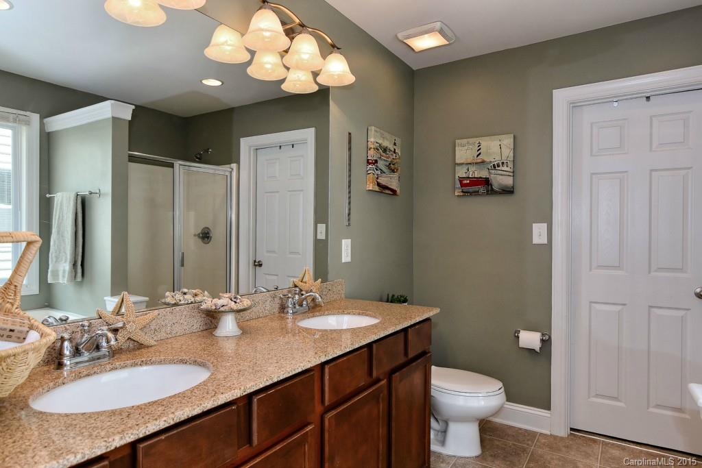 1004 Ridgehaven Road Waxhaw, NC 28173 - Photo 10 of 24 a bathroom with a sink a toilet and a mirror