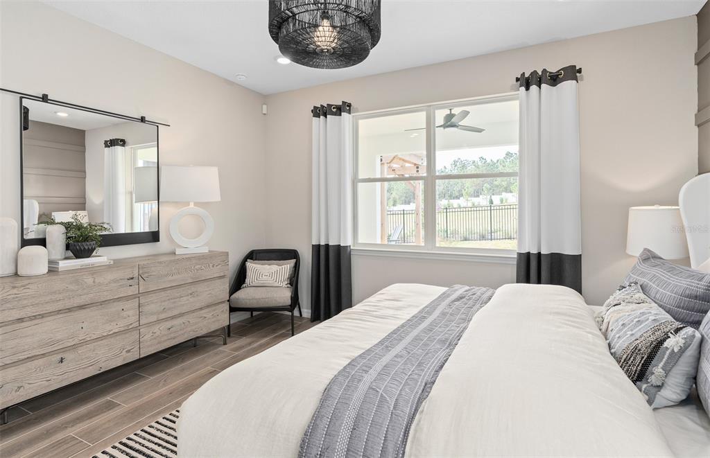 1175 Crowning Rdg Way Minneola, FL 34715 - Photo 14 of 23 a bedroom with a bed and a large window