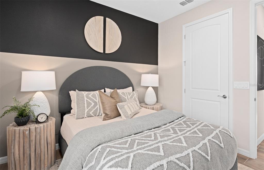 1175 Crowning Rdg Way Minneola, FL 34715 - Photo 20 of 23 a bedroom with a bed and a painting on the wall