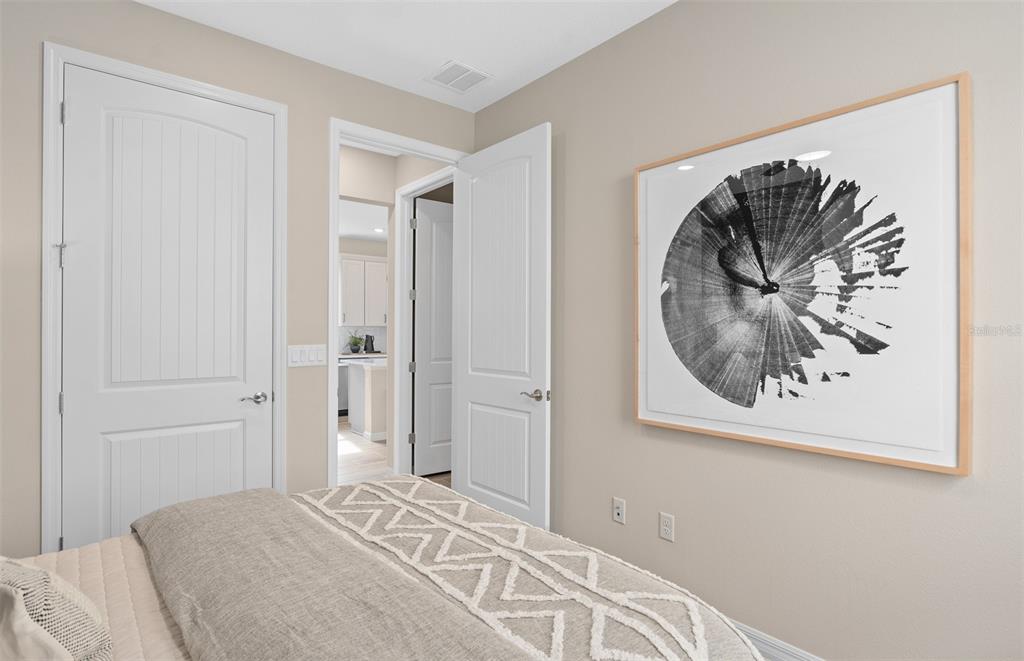 1175 Crowning Rdg Way Minneola, FL 34715 - Photo 21 of 23 a bedroom with a bed and a painting on the wall