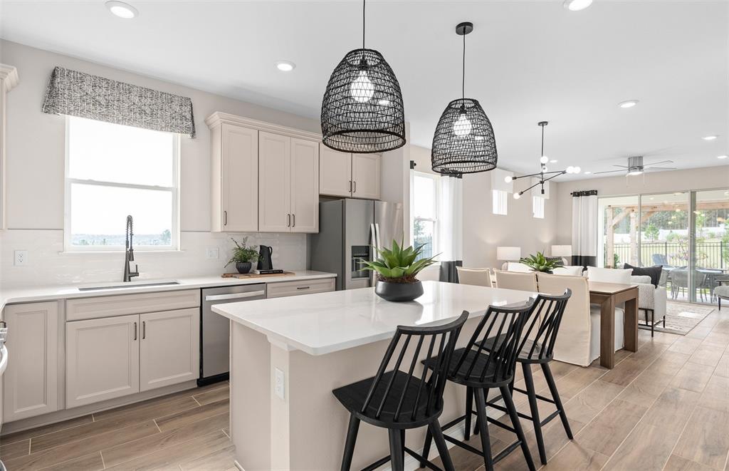 1175 Crowning Rdg Way Minneola, FL 34715 - Photo 3 of 23 a view of a dining room with furniture window and wooden floor