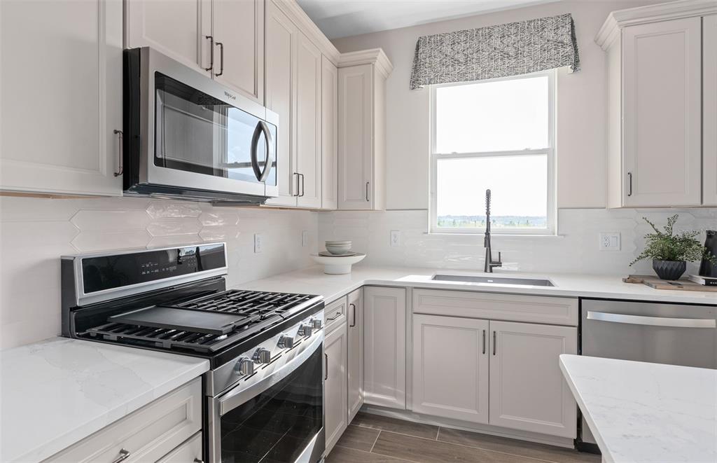 1175 Crowning Rdg Way Minneola, FL 34715 - Photo 4 of 23 a kitchen with cabinets appliances a sink and a window