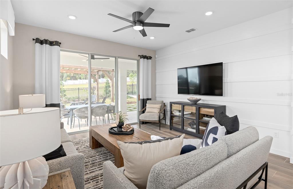 1175 Crowning Rdg Way Minneola, FL 34715 - Photo 10 of 23 a living room with furniture and a flat screen tv