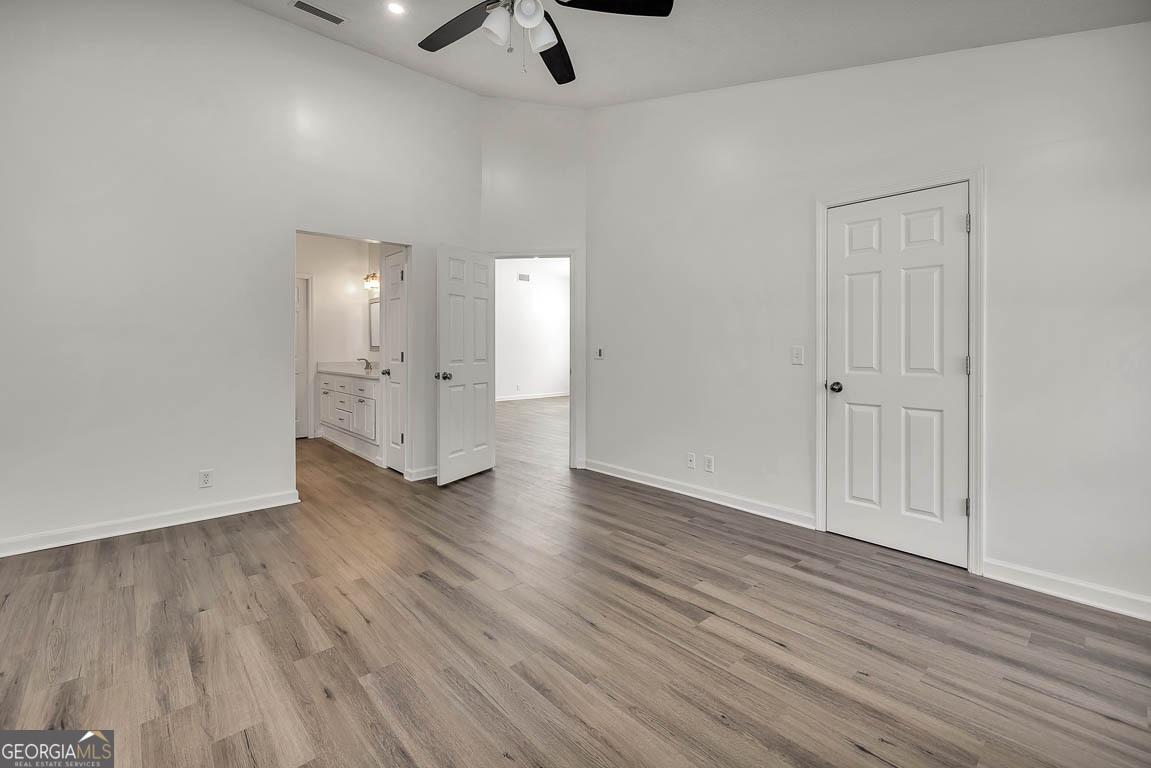 3 Bay Tree Court West St. Simons, GA 31522 - Photo 13 of 36 wooden floor in an empty room with a window