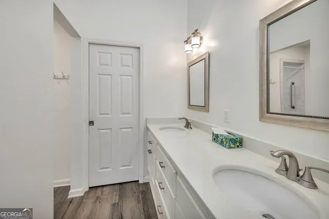 a bathroom with a double vanity sink and a mirror