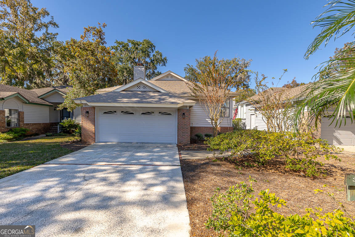 3 Bay Tree Court West St. Simons, GA 31522 - Photo 2 of 36 a front view of a house with garden