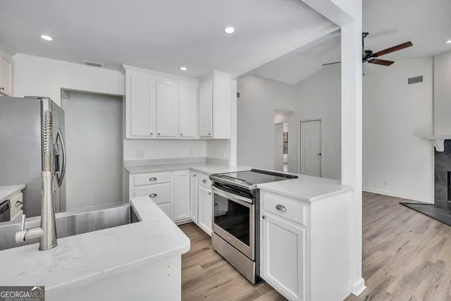 a view of an empty room and wooden floor