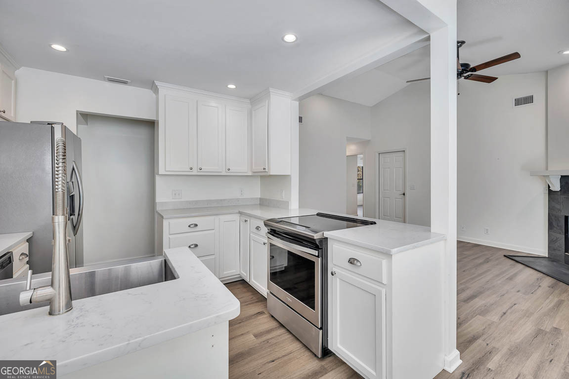 3 Bay Tree Court West St. Simons, GA 31522 - Photo 21 of 36 a kitchen with a stove sink and refrigerator